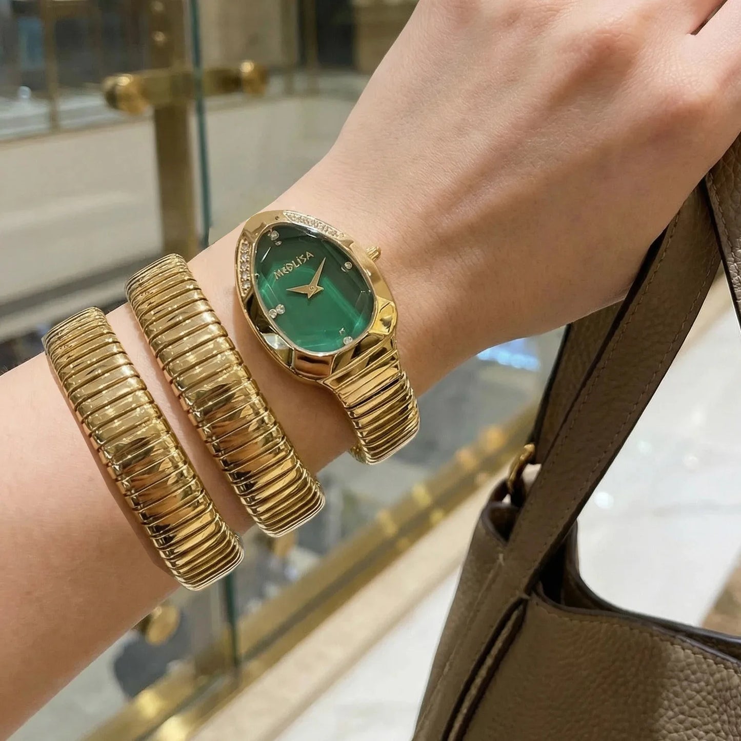 Women's wristwatch with unique snake-shaped design.